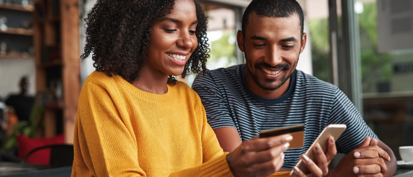 family driving on vacation, dad checks mobile banking in passenger seat